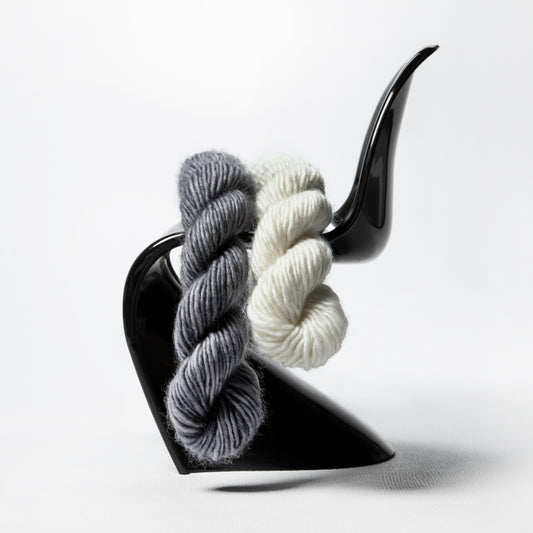 Porterness Studio Framed Photographic Print - White and Gray Yarn on A Black Mid-Century S Chairmed poster